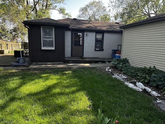 back of house with a yard and fence