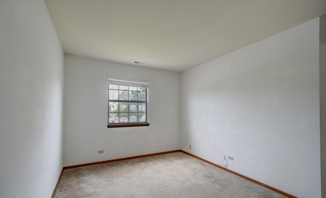 unfurnished room with carpet and baseboards