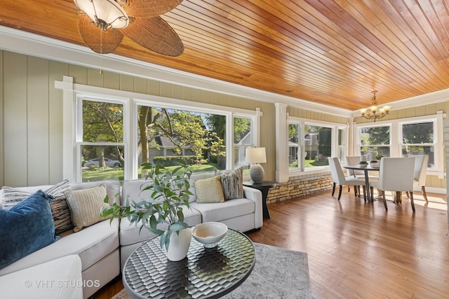 sunroom / solarium featuring a chandelier