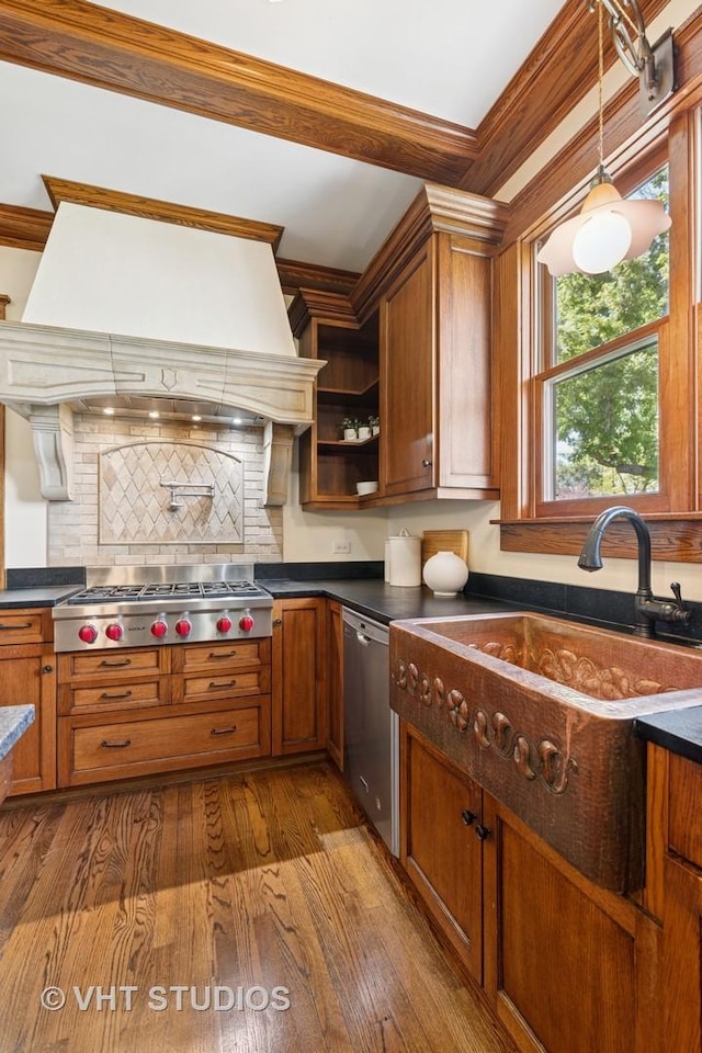 kitchen featuring custom exhaust hood, dark countertops, stainless steel appliances, brown cabinetry, and open shelves