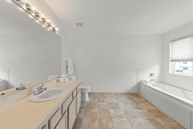 2013 Graystone Dr, Joliet, IL 60431 - full bathroom featuring a garden tub, vanity, toilet, and baseboards