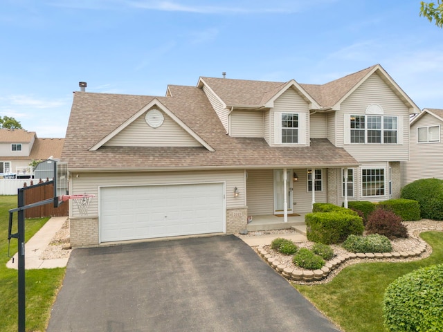 2013 Graystone Dr, Joliet, IL 60431 - traditional-style home featuring brick siding, covered porch, driveway, and roof with shingles