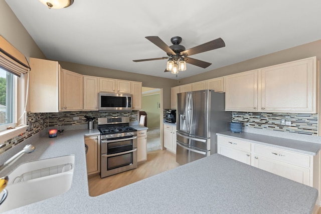 2013 Graystone Dr, Joliet, IL 60431 - kitchen featuring stainless steel appliances, a sink, tasteful backsplash, and light wood-style floors