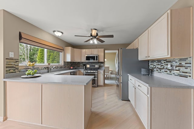 2013 Graystone Dr, Joliet, IL 60431 - kitchen with appliances with stainless steel finishes, tasteful backsplash, a peninsula, light brown cabinetry, and ceiling fan