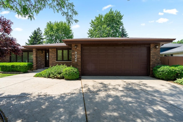 9228 Ridgeland Ave, Oak Lawn, IL 60453 - view of front of house with brick siding, concrete driveway, and an attached garage