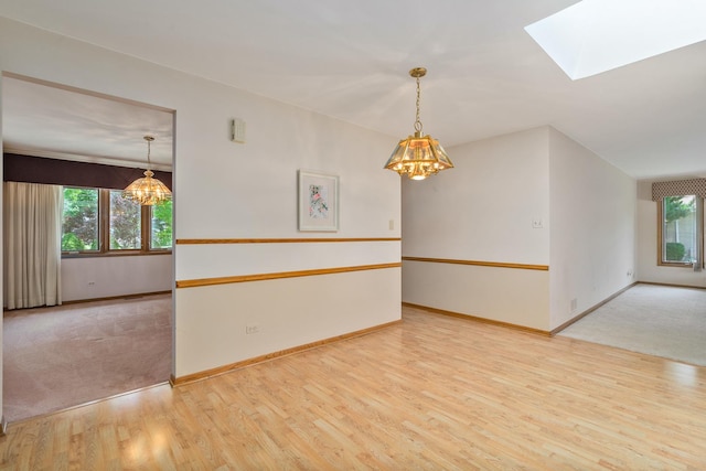 9228 Ridgeland Ave, Oak Lawn, IL 60453 - spare room featuring a chandelier, wood finished floors, and a skylight