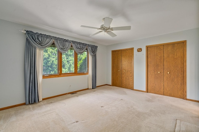 9228 Ridgeland Ave, Oak Lawn, IL 60453 - unfurnished bedroom with multiple closets, carpet, and ceiling fan