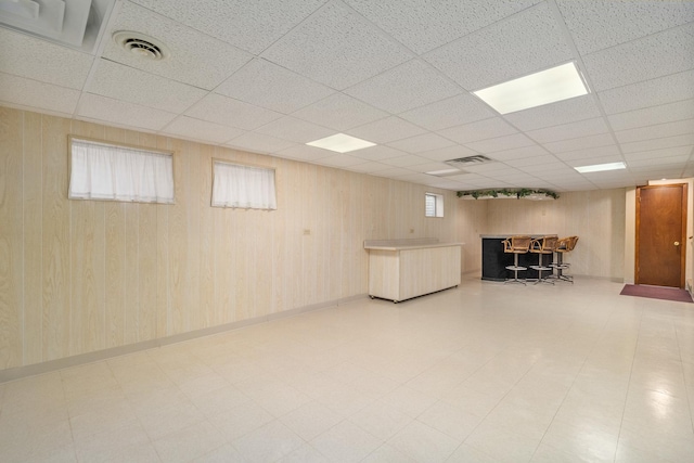 9228 Ridgeland Ave, Oak Lawn, IL 60453 - basement with a bar, a paneled ceiling, and wooden walls