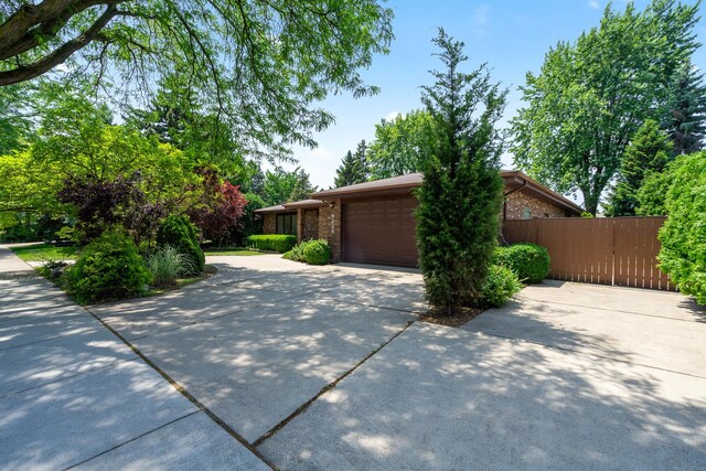 9228 Ridgeland Ave, Oak Lawn, IL 60453 - view of front of house featuring an attached garage, brick siding, and driveway