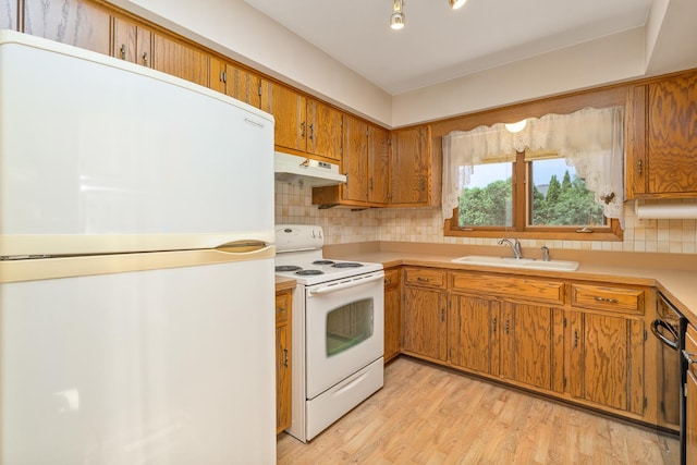 9228 Ridgeland Ave, Oak Lawn, IL 60453 - kitchen with white appliances, under cabinet range hood, brown cabinets, backsplash, and light countertops