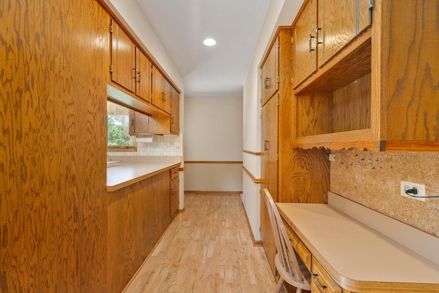 9228 Ridgeland Ave, Oak Lawn, IL 60453 - kitchen featuring decorative backsplash, light countertops, brown cabinetry, light wood-style floors, and recessed lighting