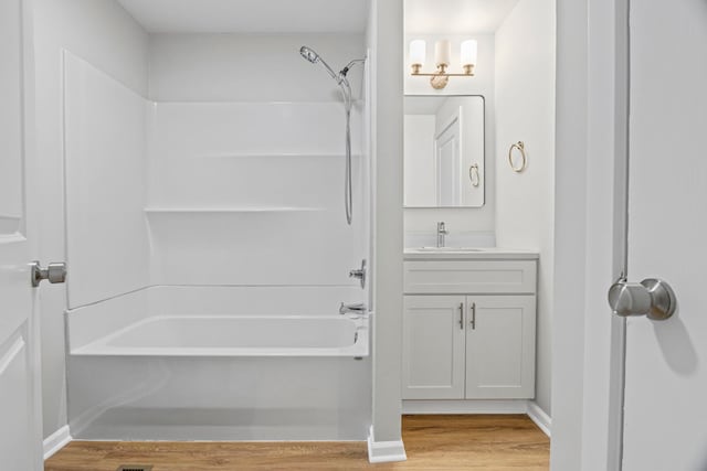 764 Terrace Ct Unit A, Elgin, IL 60120 - full bath featuring vanity, tub / shower combination, baseboards, and wood finished floors