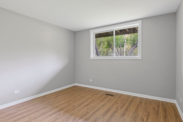 764 Terrace Ct Unit A, Elgin, IL 60120 - empty room with baseboards, visible vents, and wood finished floors