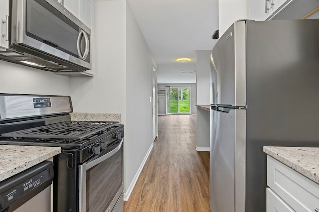 764 Terrace Ct Unit A, Elgin, IL 60120 - kitchen with light wood-style floors, white cabinetry, and appliances with stainless steel finishes