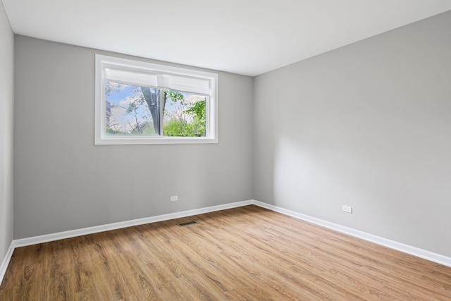 764 Terrace Ct Unit A, Elgin, IL 60120 - spare room with baseboards, visible vents, and light wood-style floors