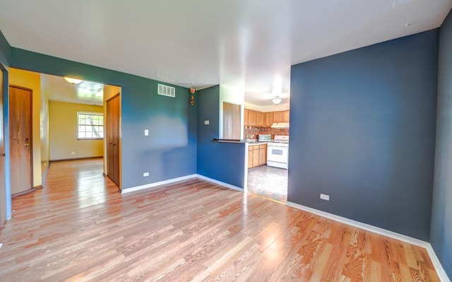 99 Gant Cir Unit C, Streamwood, IL 60107 - unfurnished living room with light wood-style floors, visible vents, and baseboards