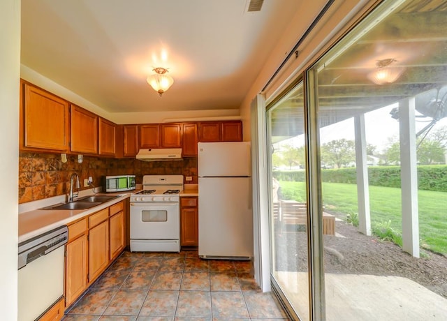 99 Gant Cir Unit C, Streamwood, IL 60107 - kitchen with a healthy amount of sunlight, white appliances, under cabinet range hood, and a sink