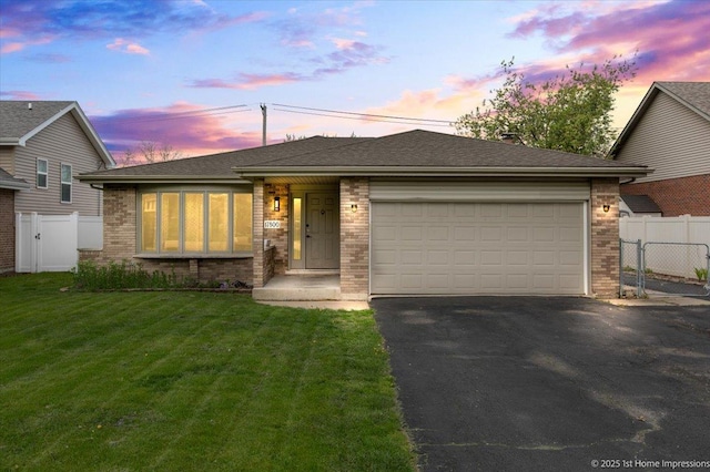 17800 Ridgeland Ave, Tinley Park, IL 60477 - view of front facade with aphalt driveway, fence, an attached garage, and brick siding