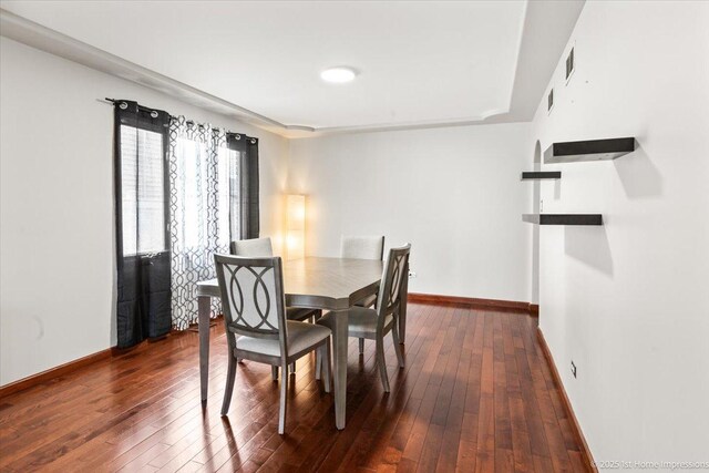 17800 Ridgeland Ave, Tinley Park, IL 60477 - dining area with dark wood finished floors, visible vents, and baseboards