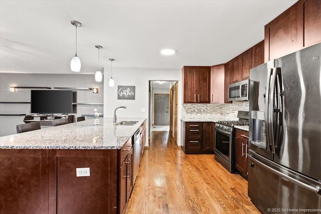 17800 Ridgeland Ave, Tinley Park, IL 60477 - kitchen with a sink, light wood-type flooring, pendant lighting, backsplash, and appliances with stainless steel finishes