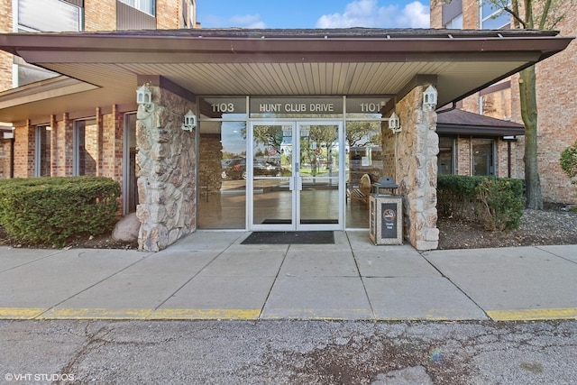 entrance to property featuring brick siding