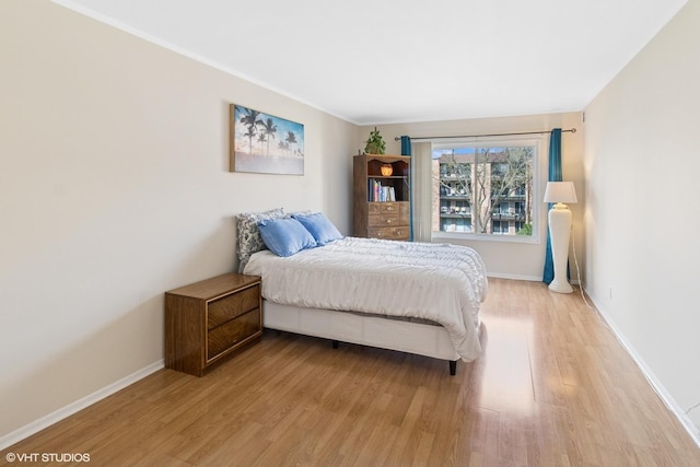 bedroom featuring baseboards and light wood-type flooring