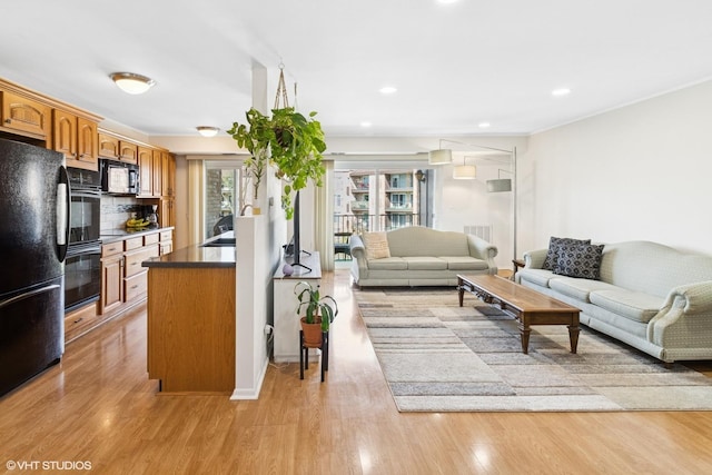 living room with light wood-style floors and recessed lighting
