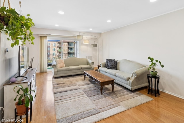 living room featuring recessed lighting, baseboards, and wood finished floors