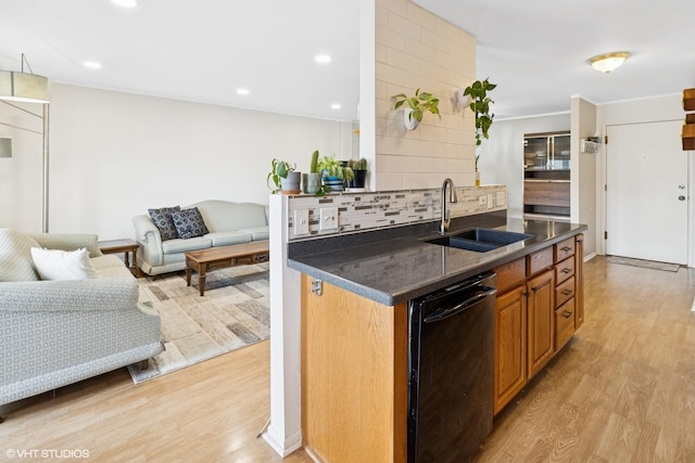 kitchen featuring a sink, recessed lighting, dishwasher, light wood-style flooring, and decorative backsplash