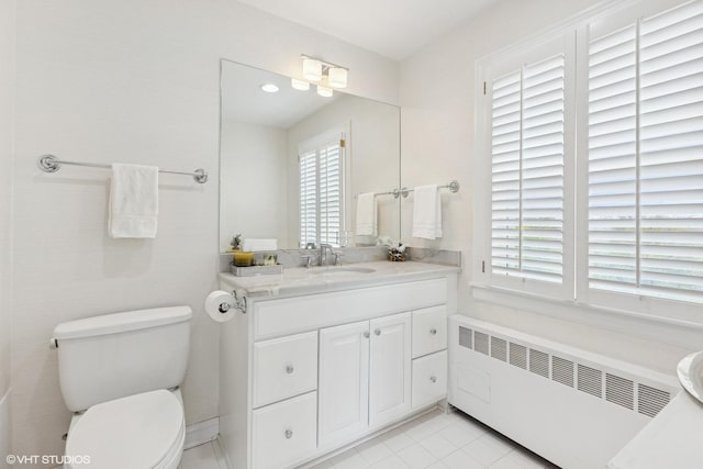 bathroom featuring radiator, toilet, tile patterned flooring, and vanity