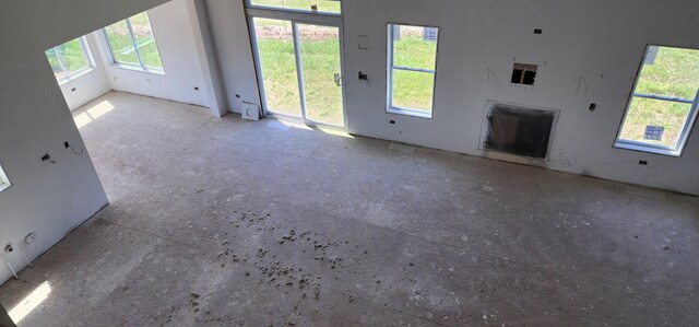 24415 W Quail Dr, Channahon, IL 60410 - unfurnished living room featuring plenty of natural light and a fireplace