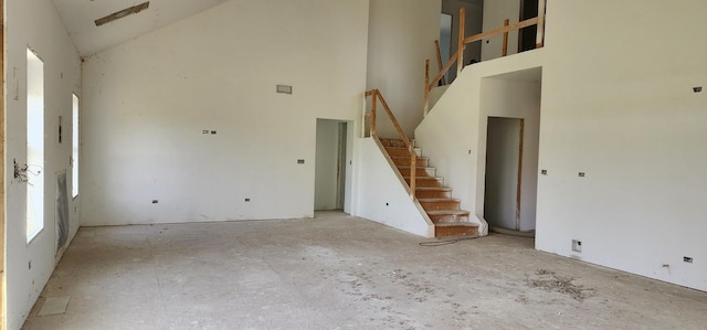 24415 W Quail Dr, Channahon, IL 60410 - unfurnished living room featuring stairway and a towering ceiling