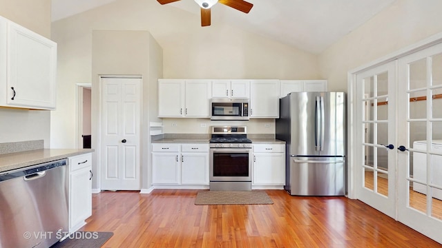 376 Willow Rd, Lakemoor, IL 60051 - kitchen with appliances with stainless steel finishes, a ceiling fan, light countertops, white cabinets, and light wood-style floors