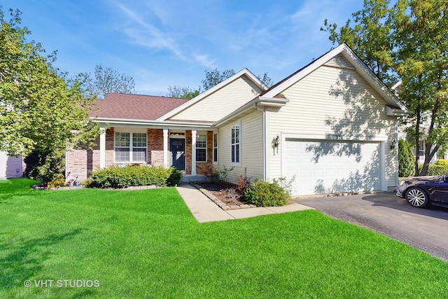 376 Willow Rd, Lakemoor, IL 60051 - single story home featuring a front lawn, asphalt driveway, a garage, brick siding, and a porch