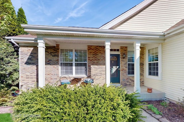 376 Willow Rd, Lakemoor, IL 60051 - view of exterior entry with a porch and brick siding