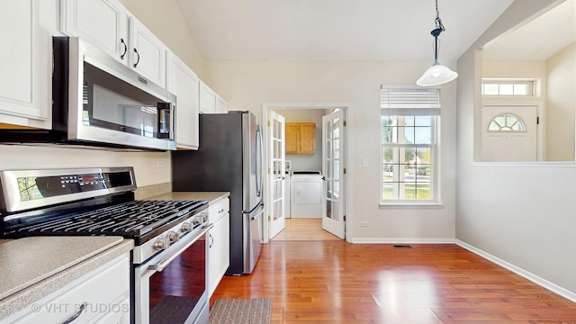 376 Willow Rd, Lakemoor, IL 60051 - kitchen with stainless steel appliances, light wood finished floors, white cabinets, pendant lighting, and light countertops