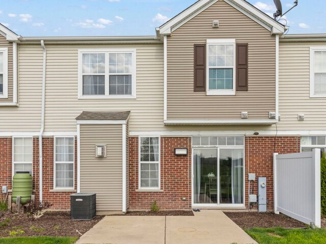 8529 Sawyer Ct, Joliet, IL 60431 - back of property with brick siding, a patio, and central air condition unit