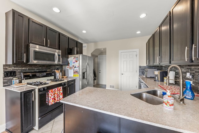 8529 Sawyer Ct, Joliet, IL 60431 - kitchen featuring stainless steel appliances, a sink, backsplash, recessed lighting, and light tile patterned flooring