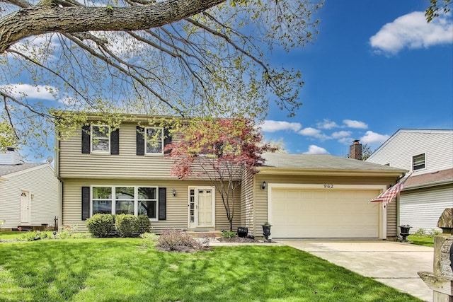 962 Thompson Blvd, Buffalo Grove, IL 60089 - colonial house featuring driveway, an attached garage, and a front yard