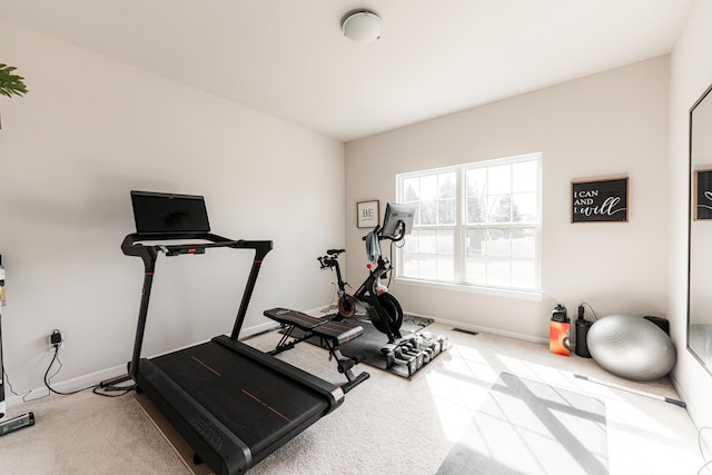 exercise area featuring carpet, baseboards, and visible vents