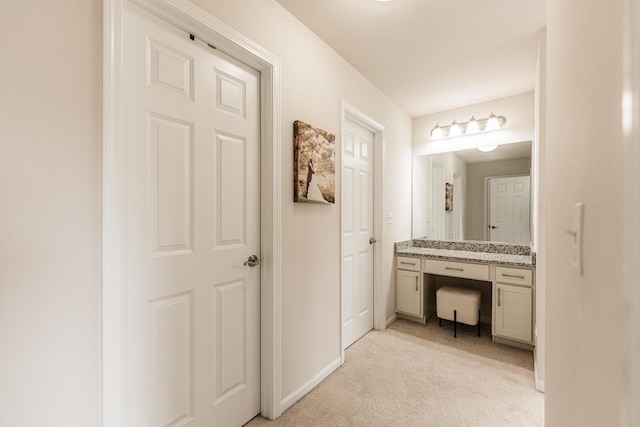 bathroom with vanity and baseboards
