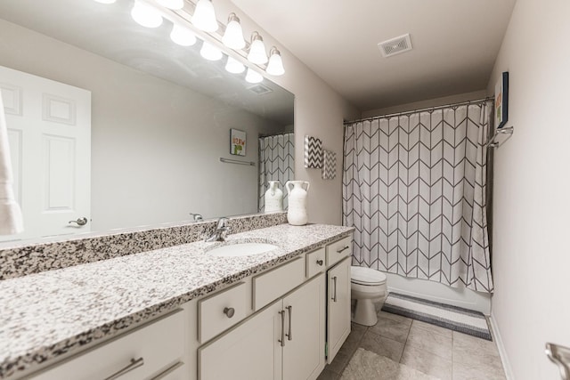bathroom featuring toilet, vanity, visible vents, tile patterned floors, and shower / tub combo