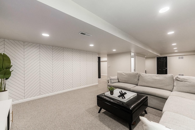 carpeted living area with baseboards, visible vents, and recessed lighting