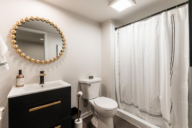 bathroom with toilet, wood finished floors, a shower with curtain, baseboards, and vanity