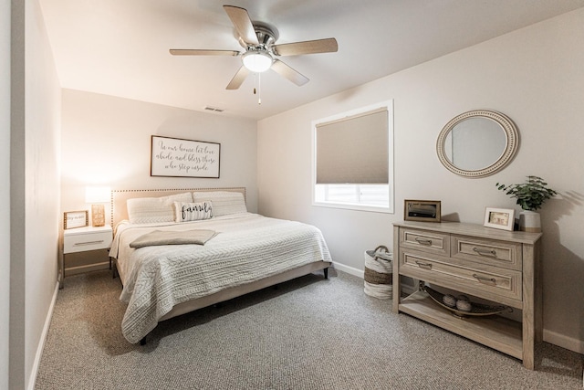 carpeted bedroom featuring visible vents, baseboards, and a ceiling fan