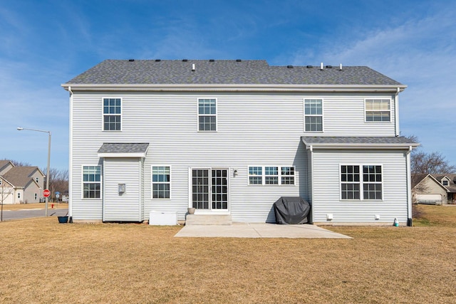rear view of house featuring a patio area and a lawn