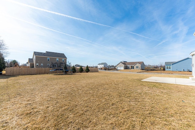 view of yard featuring a residential view and fence