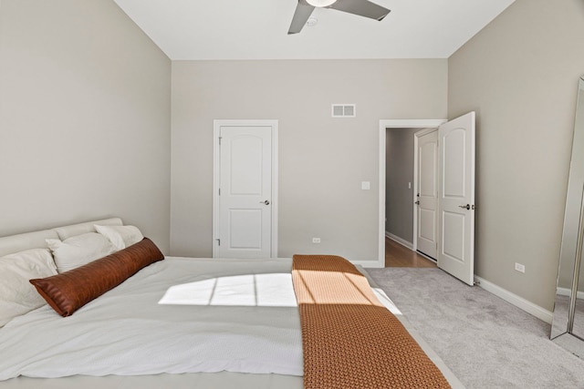 carpeted bedroom with baseboards, a ceiling fan, and visible vents