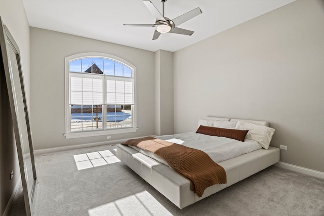 bedroom with baseboards, ceiling fan, and carpet floors