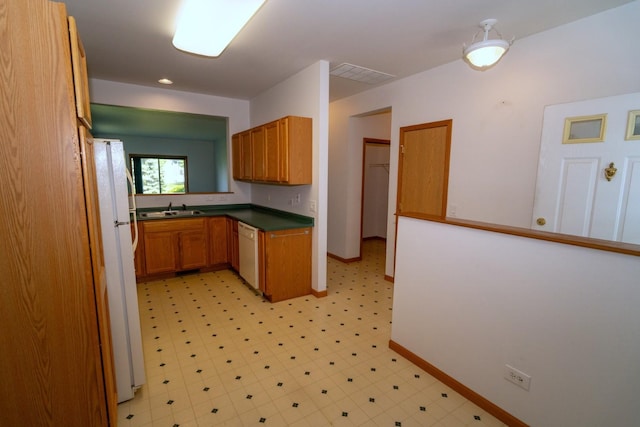 3404 Steeplechase Way, Grayslake, IL 60030 - kitchen with white appliances, a sink, brown cabinets, light flooring, and baseboards